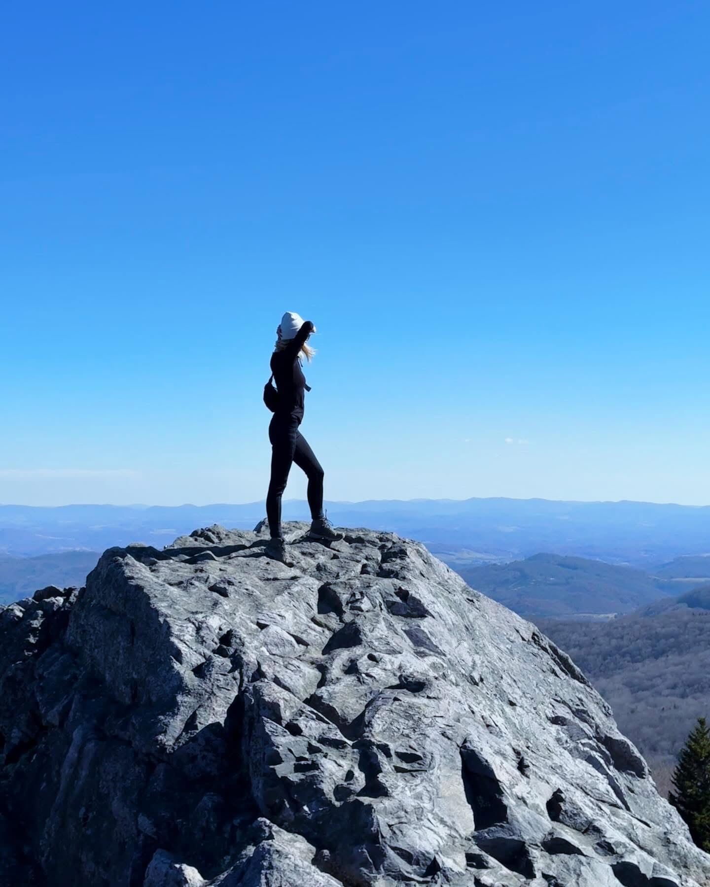 Nicole standing on a rocky Appalachian summit